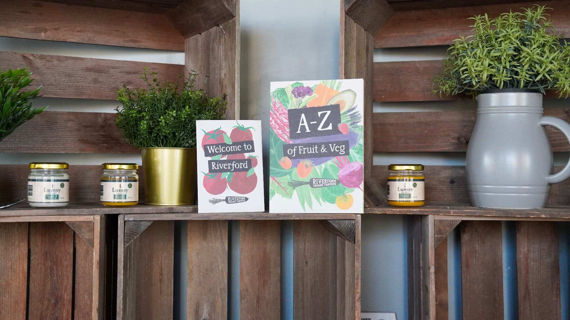 Lumsy organic baby food jars styled on a farm shop shelf